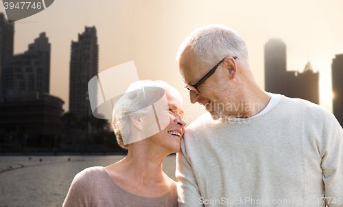 Image of senior couple over dubai city street background