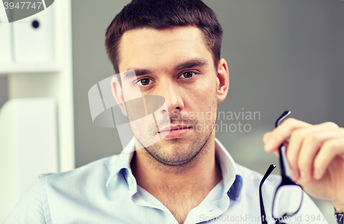 Image of portrait of businessman with eyeglasses at office