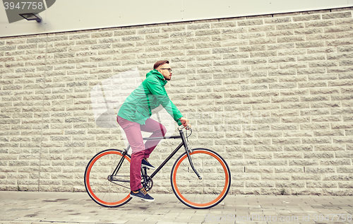 Image of young hipster man riding fixed gear bike