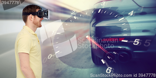 Image of man in virtual reality headset and car racing game