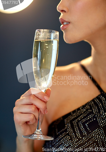 Image of close up of woman drinking champagne at party