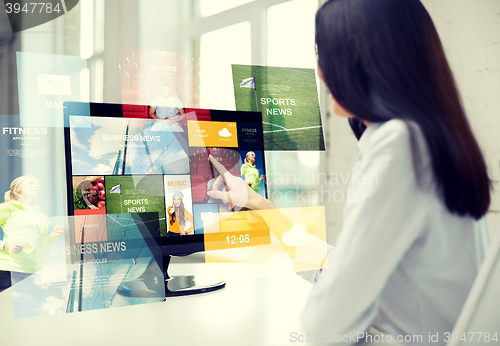 Image of close up of woman with news on computer in office