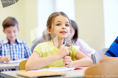Image of student girl with group of school kids in class