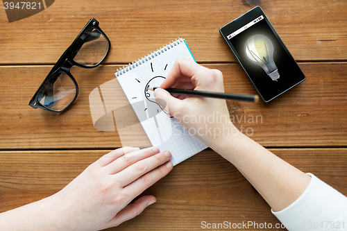 Image of close up of woman or student writing to notepad