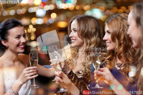 Image of happy women with champagne glasses at night club