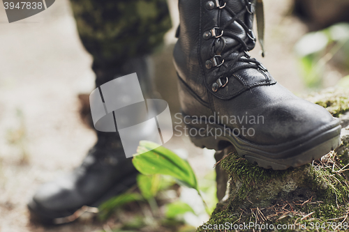 Image of close up of soldier feet with army boots in forest