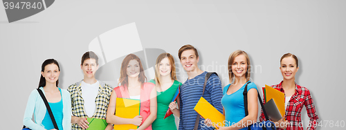 Image of group of teenage students with folders and bags