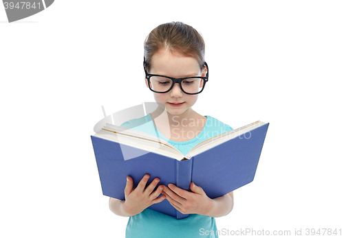 Image of happy little girl in eyeglasses reading book