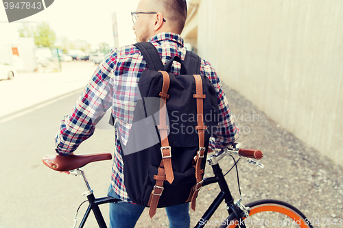 Image of hipster man with fixed gear bike and backpack