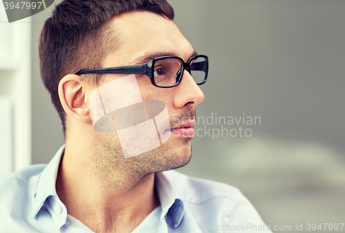 Image of portrait of businessman in eyeglasses at office