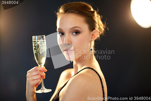 Image of young asian woman drinking champagne at party