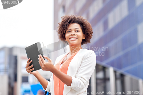 Image of happy african businesswoman with tablet pc in city
