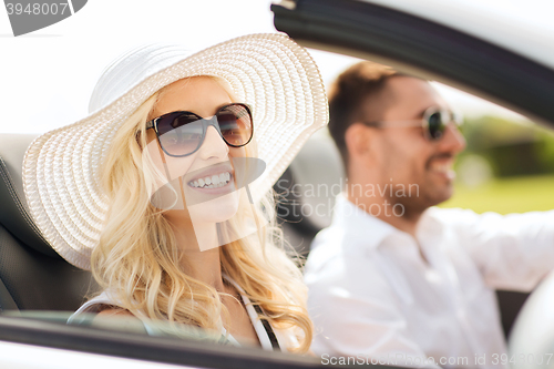 Image of happy man and woman driving in cabriolet car