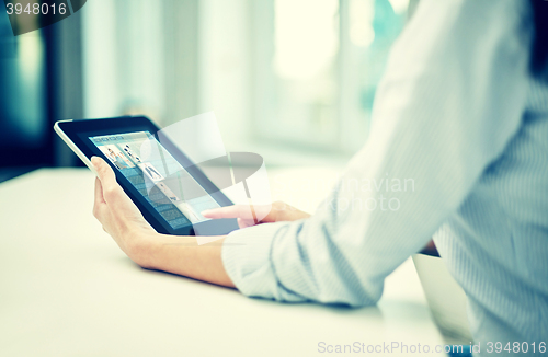 Image of close up of woman hands with tablet pc at office