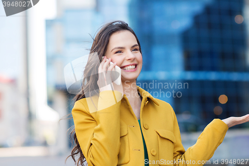 Image of smiling young woman or girl calling on smartphone