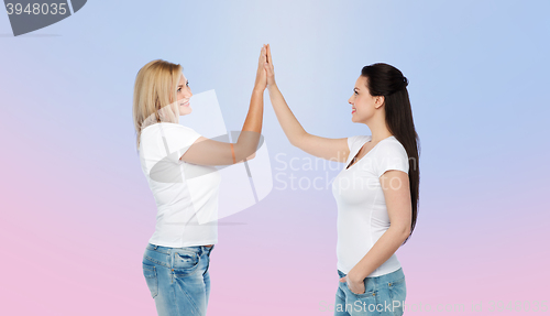 Image of group of happy different women in white t-shirts