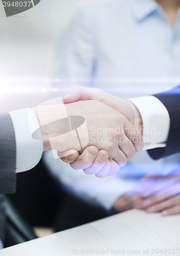 Image of two businessmen shaking hands in office