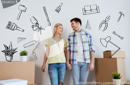 Image of smiling couple with big boxes moving to new home