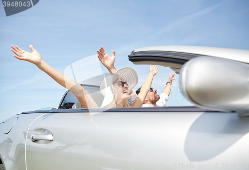 Image of happy man and woman driving in cabriolet car