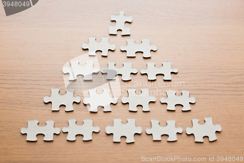 Image of close up of puzzle pieces on wooden surface