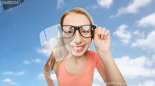 Image of happy young woman or teenage girl in eyeglasses