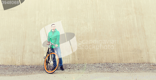 Image of happy young hipster man with fixed gear bike
