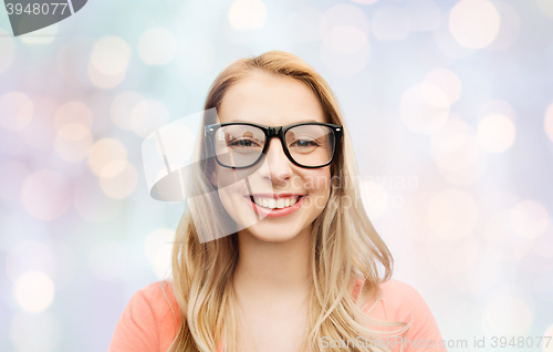 Image of happy young woman or teenage girl in eyeglasses