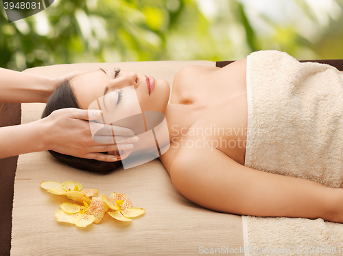 Image of woman in spa getting facial massage