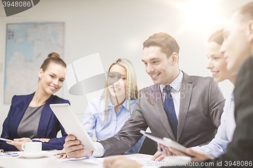 Image of business team with tablet pc having discussion