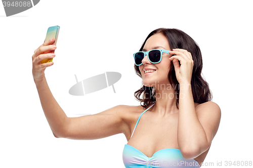 Image of woman in swimsuit taking selfie with smatphone