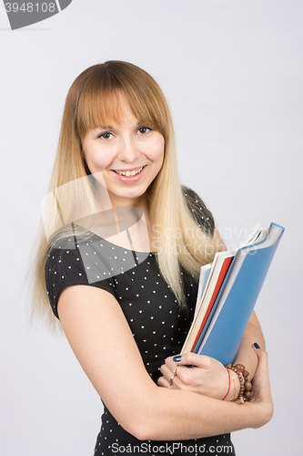 Image of Happy young girl with a folder in his hands happily smiling in the picture