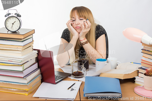 Image of Girl student fell asleep at the table drinking three cups of coffee