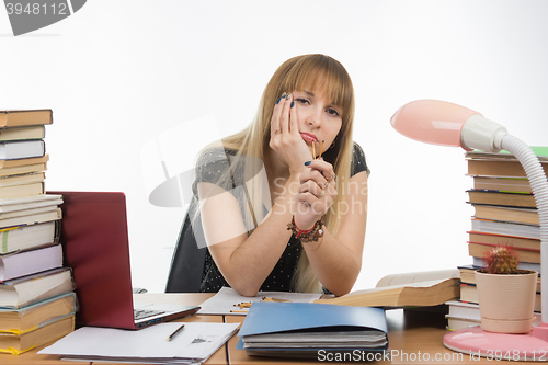 Image of Sleepy student holds in hands of match