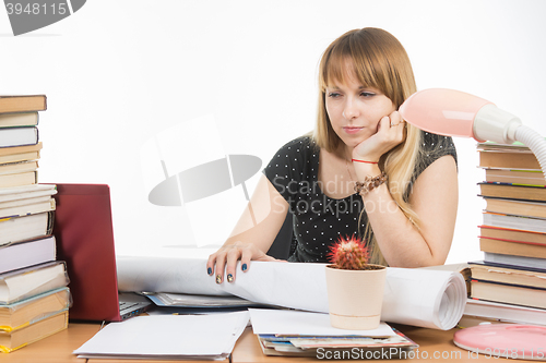 Image of Student with contempt and weariness looking at laptop monitor