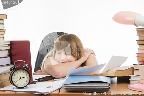 Image of Student fell asleep at the table ready for the next exam