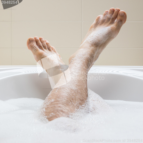 Image of Men\'s feet in a bathtub, selective focus on toes