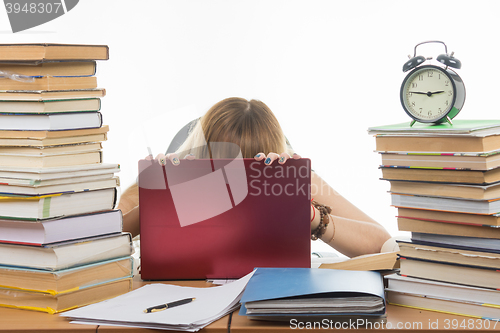 Image of Student in despair laid her head on laptop