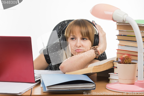 Image of Student thinking sadly looks at the laptop screen