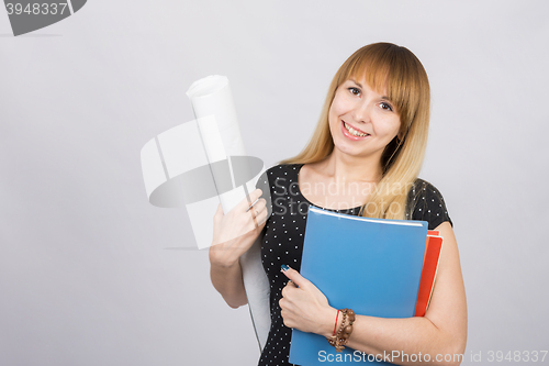 Image of Girl student smiling and holding blueprints and a folder with documents
