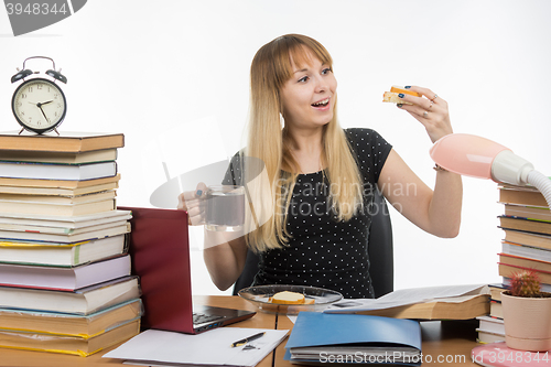 Image of Hungry young teacher very happy sandwich with coffee