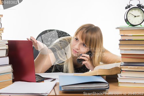 Image of Student discusses by phone coursework