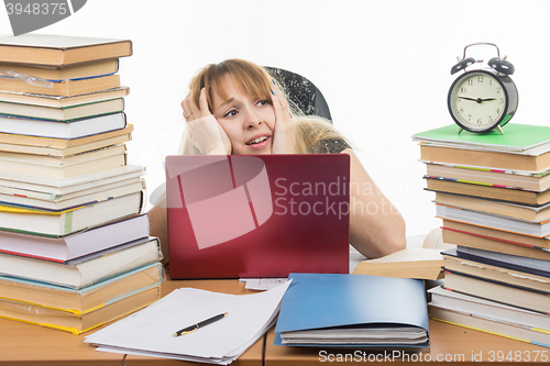 Image of The student looks at his watch and realizes that late for an exam