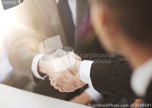 Image of two businessmen shaking hands in office