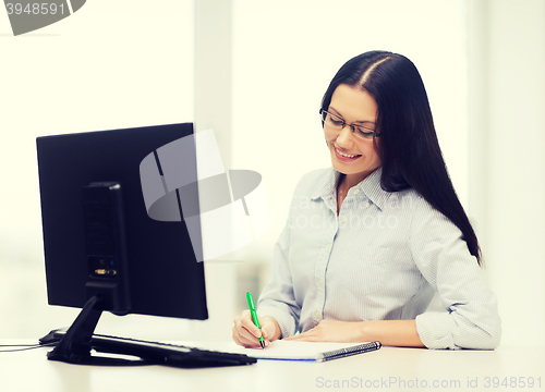 Image of smiling businesswoman or student with eyeglasses