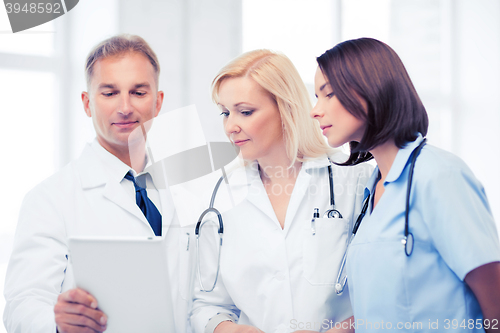 Image of doctors looking at tablet pc