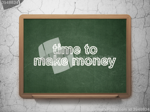 Image of Finance concept: Time to Make money on chalkboard background