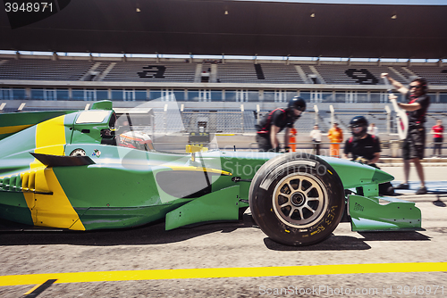 Image of Race car driver in the pitlane for a pitstop