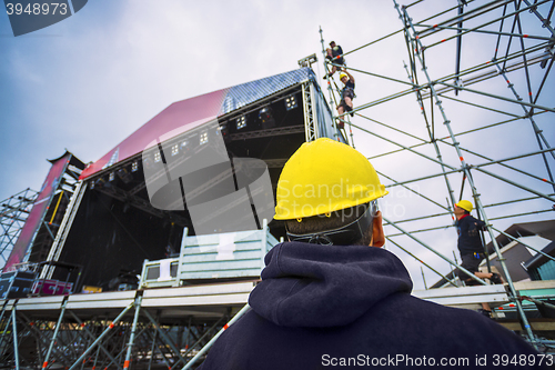 Image of building entertainment stage for music festival wearing safety c