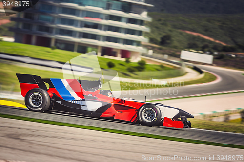 Image of Fast formula car racing on a track