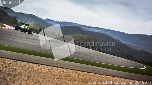 Image of racing on the track between the hills in a formula race car